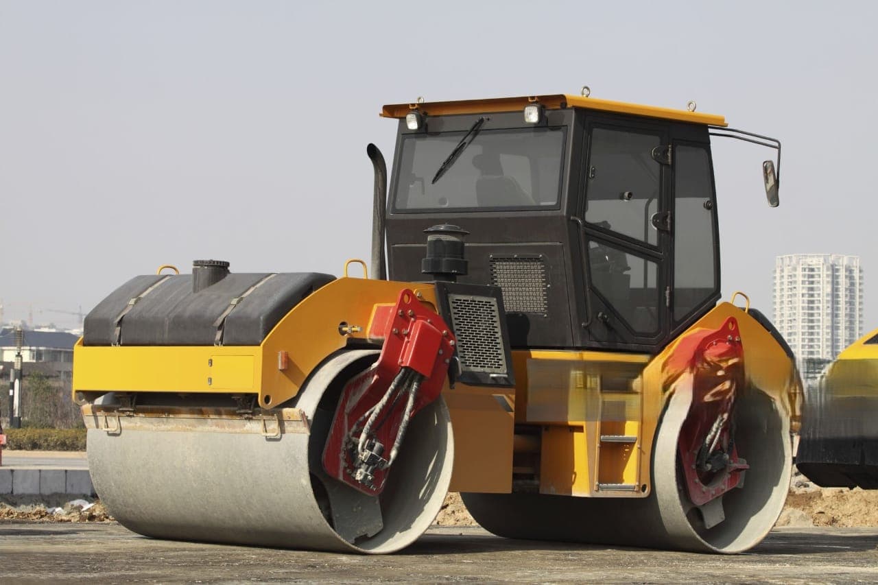 Vibratory road roller compacting asphalt